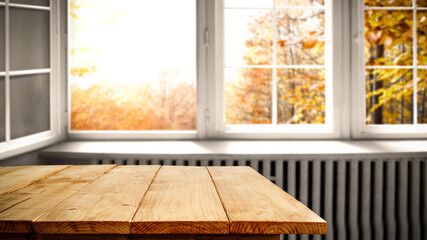 Wooden table and autumn window space 