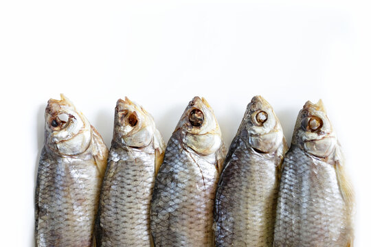 isolated close up top view dried salted caspian roaches fish on a white background