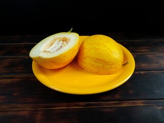 Fresh melon. Slices of melon on a black wooden table. top view.