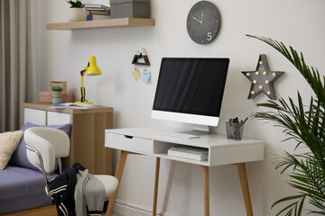 Modern teenager's room interior with stylish workplace