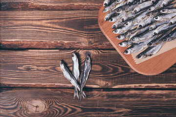 Dried fish on a wooden background. Studio photo.