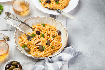 spaghetti in creamy tomato sauce with olives