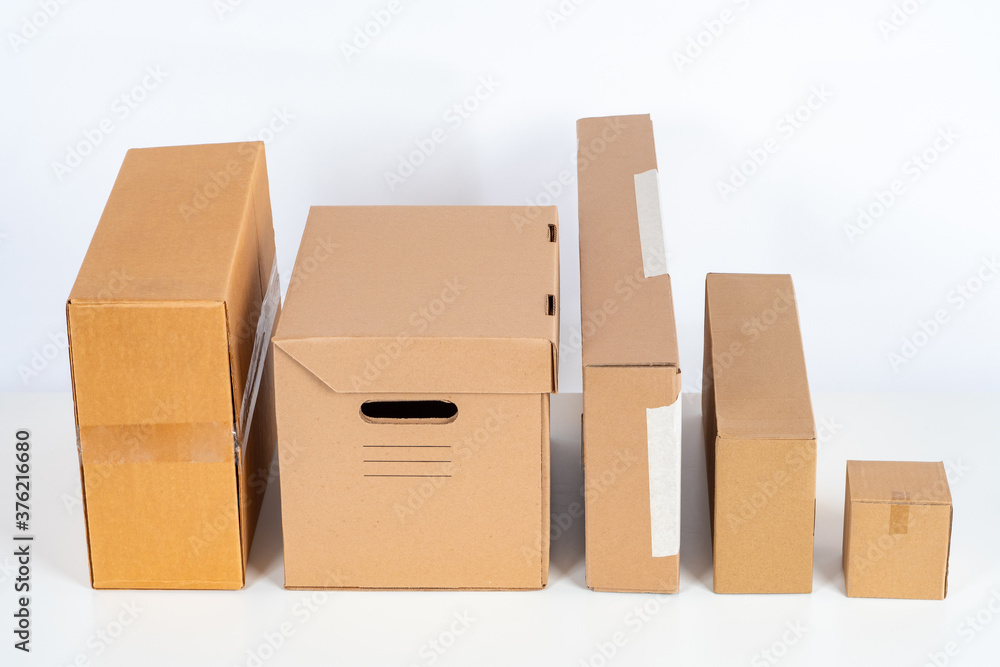 Poster boxes of different sizes stand side by side. several boxes of different shapes on white background. 