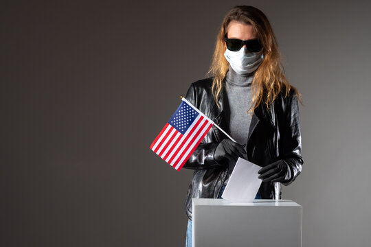 US presidential election during Covid-19. Woman voter medical mask. Medical mask and gloves as infection hazard sivmol. American woman throws her ballot into voting box. Voter in election section US - Powered by Adobe
