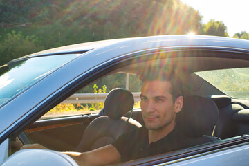 Naklejka premium A handsome and cool man driving a car