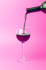 Wine is poured into a glass. Red wine is poured into a glass for tasting, minimal concept
