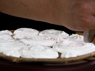 Fototapeta na wymiar making meringue cakes. egg white meringue. pastry shop. sweet