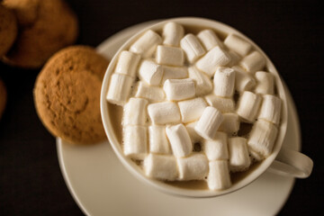 Close-up of a Cup of coffee with marshmallows and oatmeal cookies
