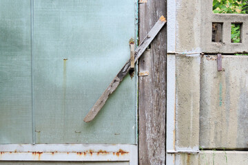 old rustic door with metal trim locked on a piece of board