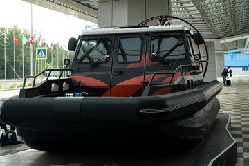 A boat with a propeller driven engine on rubber pontoons.