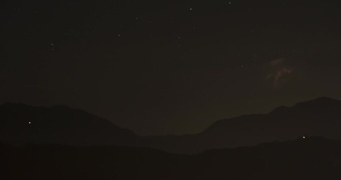 Time lapse of summer storm in the distance at night. Alps mountain range in foreground. The storm was 200 kilometers (124 miles) away. Static shot, long lens 