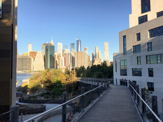 Waterfront promenade with park benches in Brooklyn Heights and panoramic view of downtown Manhattan...