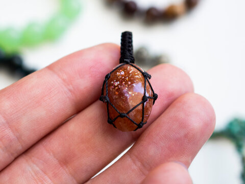 Sunstone pendant in a woman's hand