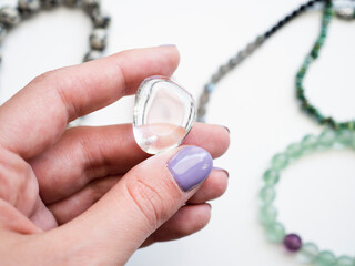 Natural white quartz pendant in a woman's hand