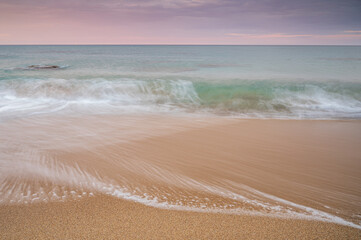 waves on a Mediterranean beach, at sunrise
