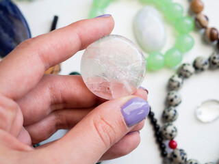 Pendant made of natural rose quartz in a woman's hand