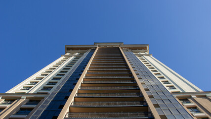 Feeling so small while standing under the tall building and the deep blue sky.