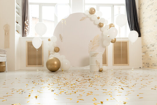 Birthday decorations - gifts, toys, balloons, garland and figure for little baby party on a white wall background.