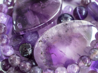 Natural amethysts of different sizes on a white background