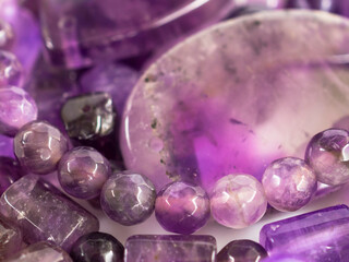 Natural amethysts of different sizes on a white background