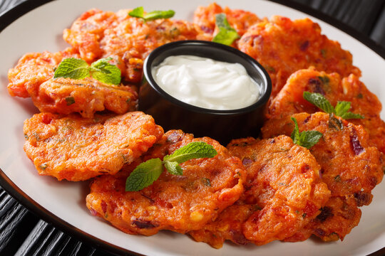 Tomatokeftedes Fried tomato balls a delicious greek ouzo meze from Santorini island close-up in a plate. Horizontal