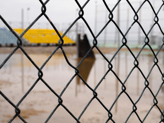 Fototapeta premium View of the playground through the fence