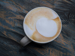 Cappuccino in a mug on a wooden table