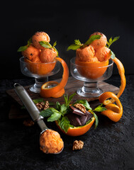 Orange ice cream with chocolate chips and nuts