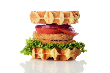 chicken burger waffle sandwich with lettuce tomato and onion on white