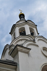 Fototapeta na wymiar church bells and cross on sky background
