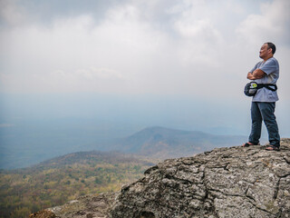 Asian Fat trekker on Yeabmek Cliff Phu Kradueng mountain national park in Loei City Thailand.Phu Kradueng mountain national park the famous Travel destination