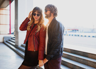 Close up fashion romantic portrait of young pretty couple kissing and hugging   on the street at...