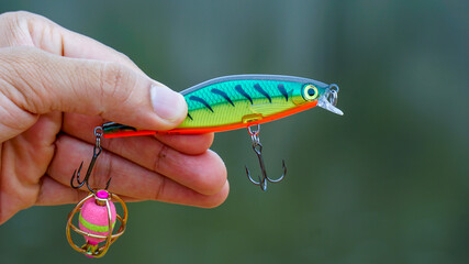 fishing lure held in hand,a fishing lure is a type of artificial fishing bait used to attract fish. Lures come in many different shapes, sizes, and colors, each designed to attract fish