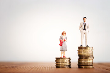 Conceptual image of gender inequality. A woman and a man with income difference