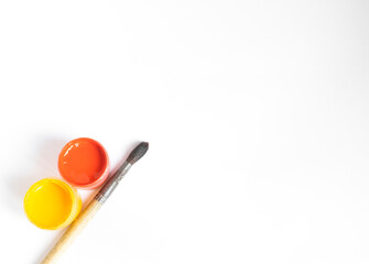Painting tools on the artist's desk and top view, painting with paints, watercolors, gouache and brush. On a white background. Copy space