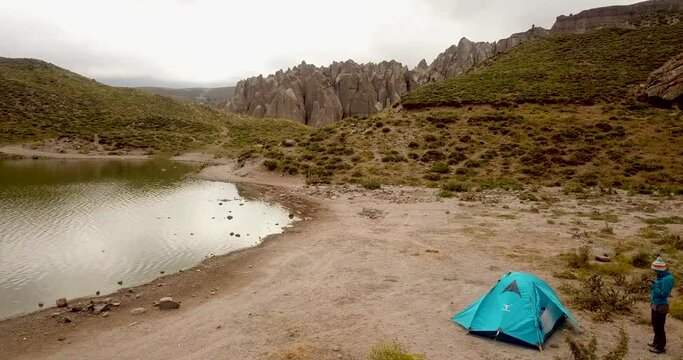 Camping by the small lake near the beautiful pillar rocks in the valley of Sabalan mountains in a cloudy day time in Iran