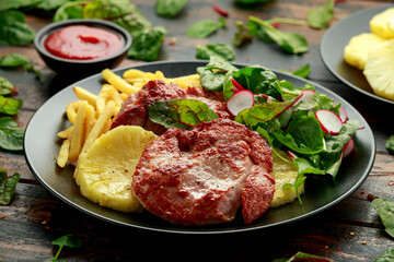 Fried Gammon steak with pineapple, french fries and vegetables