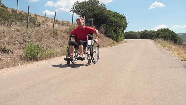 daily life of a disabled person in a wheelchair who travels a road paying attention to cars