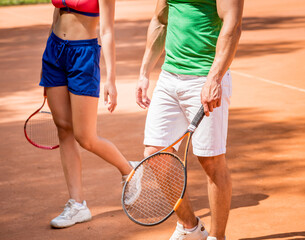 Fototapeta na wymiar Young athletic woman playing tennis with her coach.