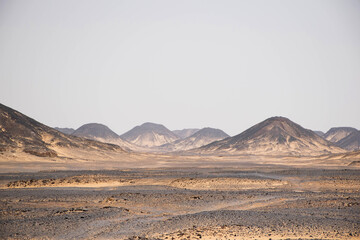 Plakat landscape black rock desert off egypt, high mountains with rocks and sand. Scenic volcanic landscape in desolate nature. Extreme travel destination. Travel background. 