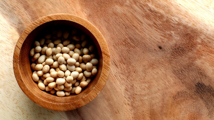 White bean seeds in a wooden bowl