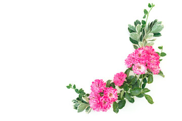 Floral frame made of pink roses flowers and leaves on white background. Flat lay