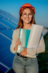 Businesswomen working on checking equipment at solar power plant with tablet checklist, woman...