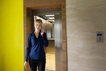 Business blonde in the office at work, with the phone