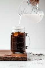 Ice coffee with milk pour