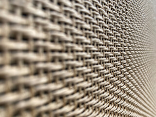 close up selective focus on middle brown cream speaker grill look Like woven bamboo with Blur the edges can use for background, backdrop and texture with copy space for letter. Side view angle.