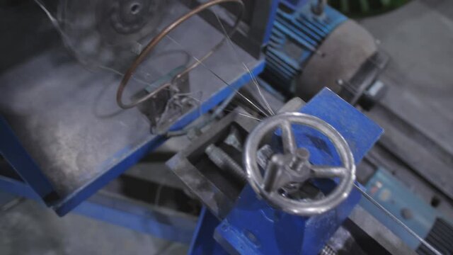 The netting of aluminum wire using special equipment at the factory for the manufacture of electric cable. Manufacture of electric cable.