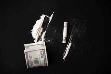 White powder as drug with money on black surface, concept picture