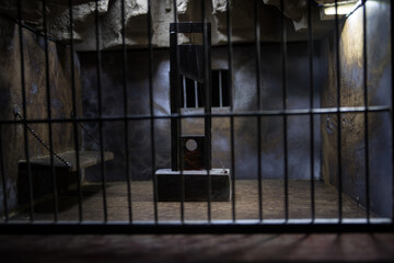 Jail or prison cell. Obsolete gray grunge concrete room. Creative artwork decoration. Horror view...