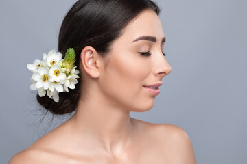 Portrait of a beautiful happy woman with beautiful fresh make-up and with clean skin, with a wedding hairstyle in a beauty salon. The hairdresser done the hairstyle. Wedding hairstyle.